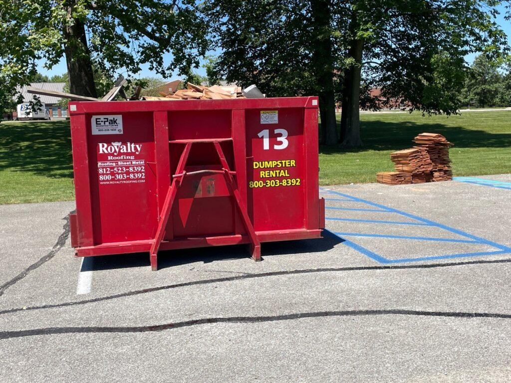 royalty roofing dumpster placed by job site