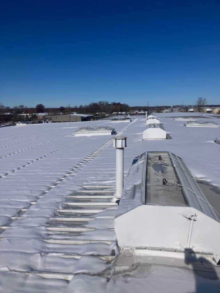 commercial metal roof covered in snow
