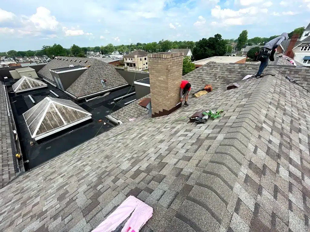 Royalty Roofing crew installing new architectural shingles at Jackson County Public Library in Seymour Indiana