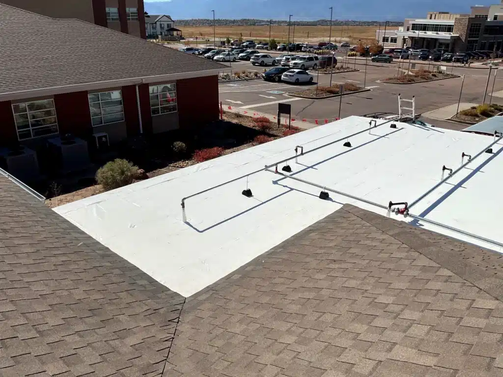 Shingle roof and flat roof replacement completed at Peak View Behavioral Health in Colorado Springs, Colorado.
